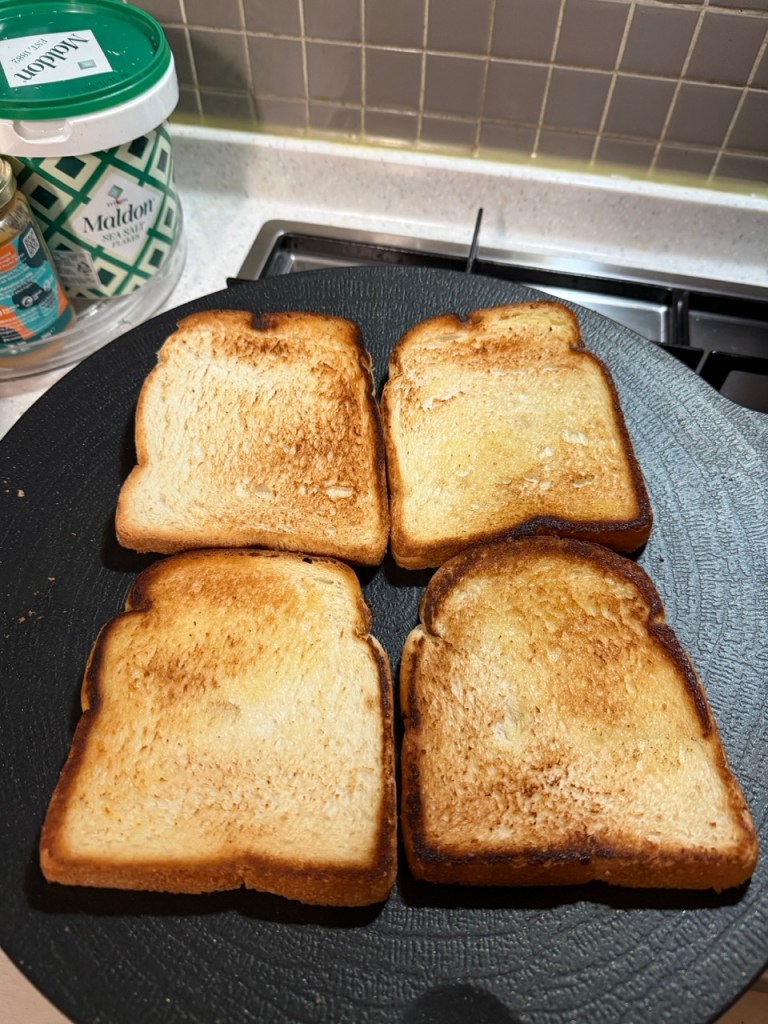 A classic homemade Korean street toast with egg, cabbage, and sugar on a wooden plate.