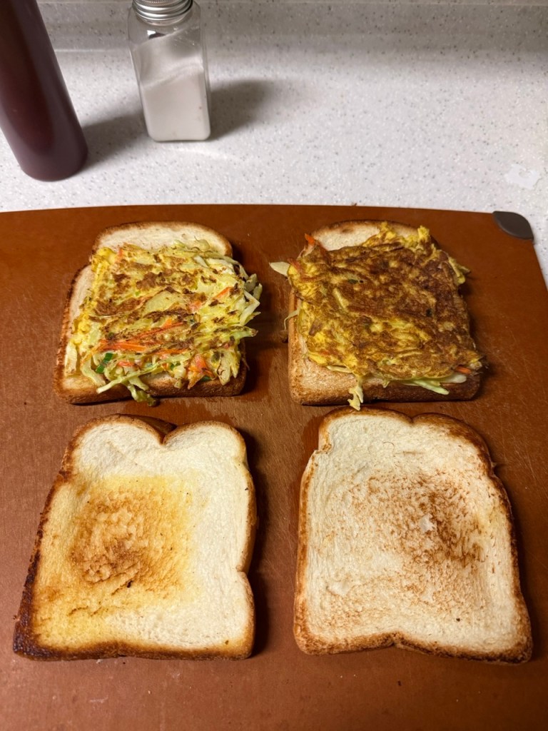 A classic homemade Korean street toast with egg, cabbage, and sugar on a wooden plate.
