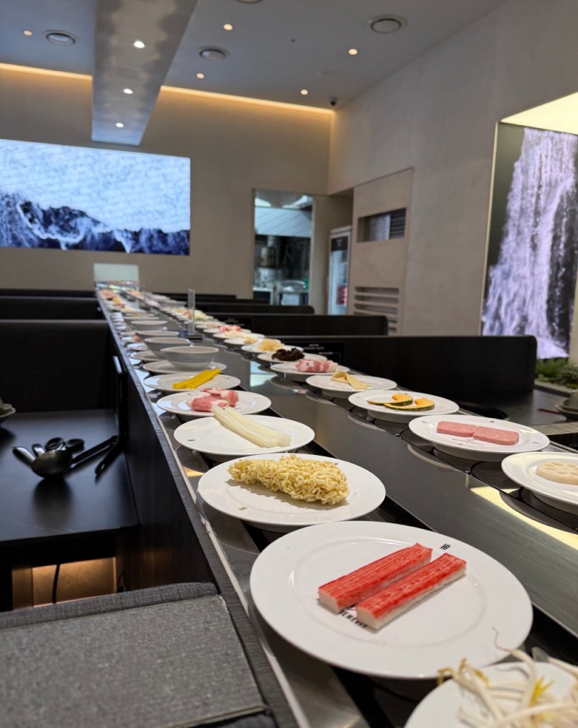 A wide variety of fresh vegetables, noodles, and mushrooms at the self-bar.