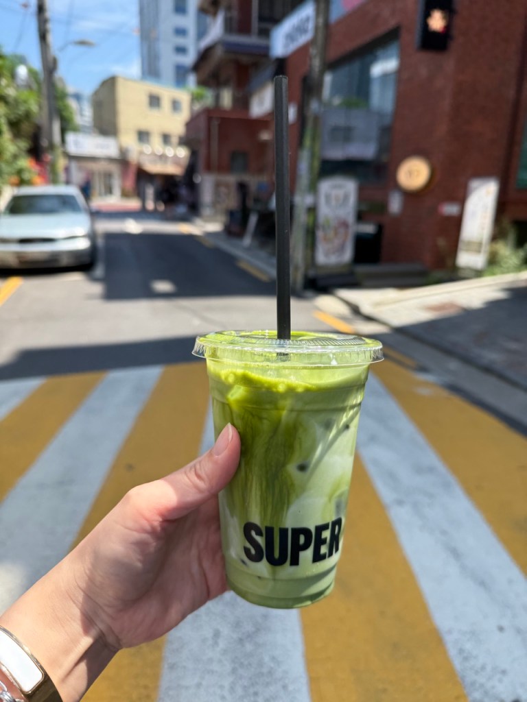 The iconic layered green matcha and white milk latte in a clear cup