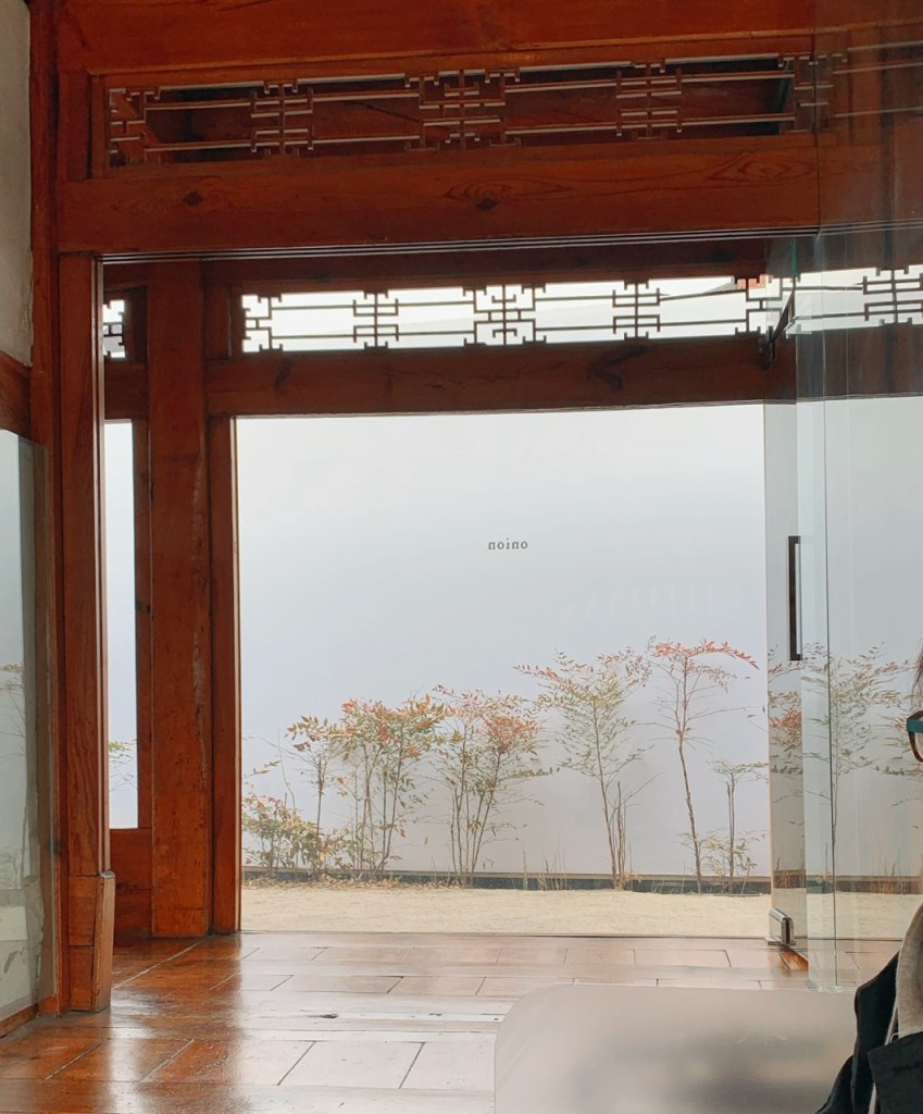 The view of the inner courtyard through large glass windows of the cafe.