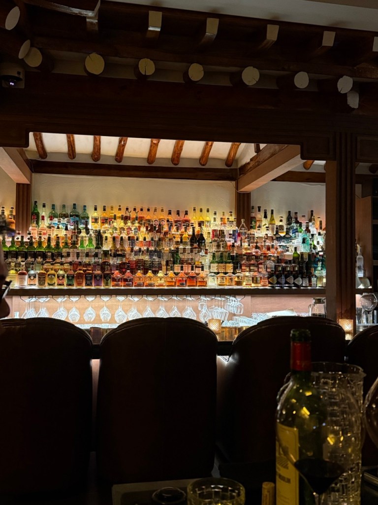 The sophisticated and cozy wooden bar seating area inside the Hanok.