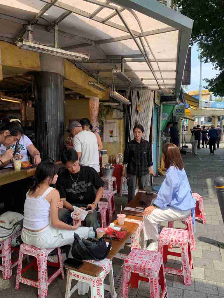 People enjoying coffee and snacks at the trendy Cafe Onion in Gwangjang Market.