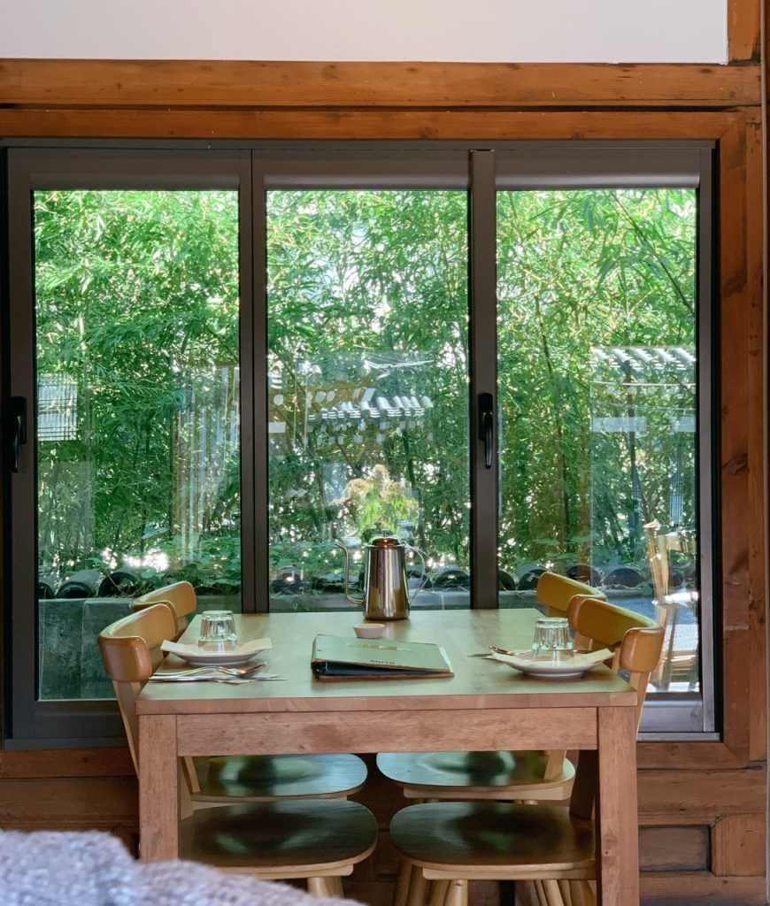 The view of the serene inner courtyard through the large glass windows.