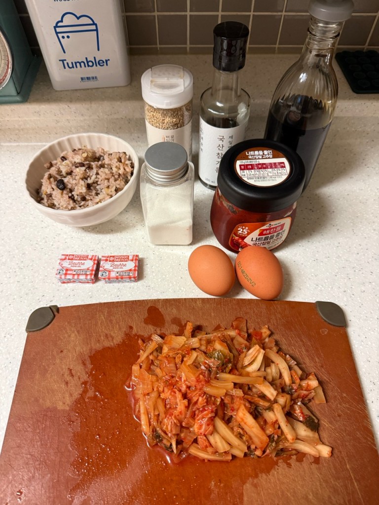 Chopped Kimchi, green onions, and bacon bits prepared for fried rice.
