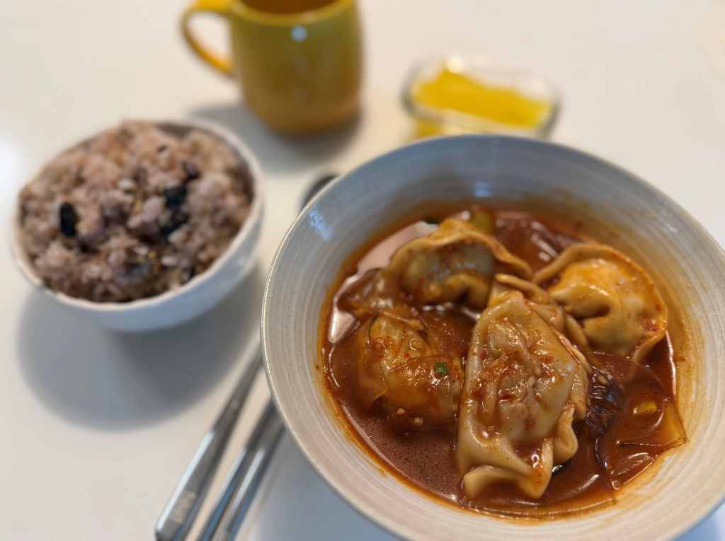 A close-up of a juicy dumpling filled with meat and vegetables.