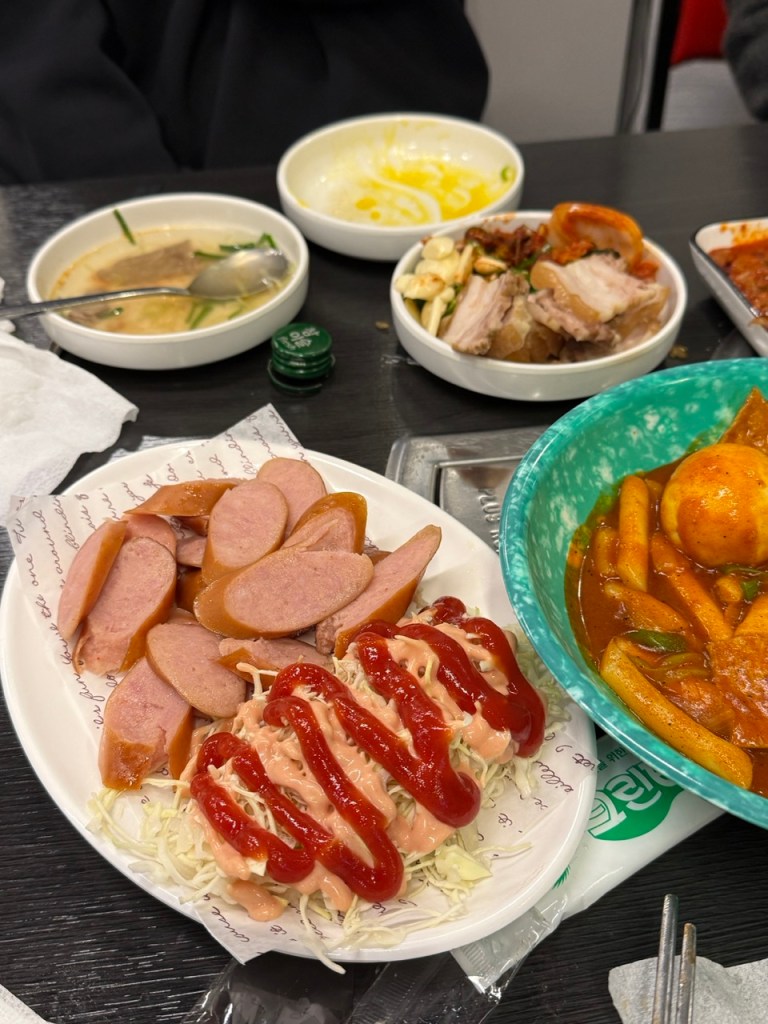 Continuous serving of various small plates and appetizers in an authentic Korean restaurant.