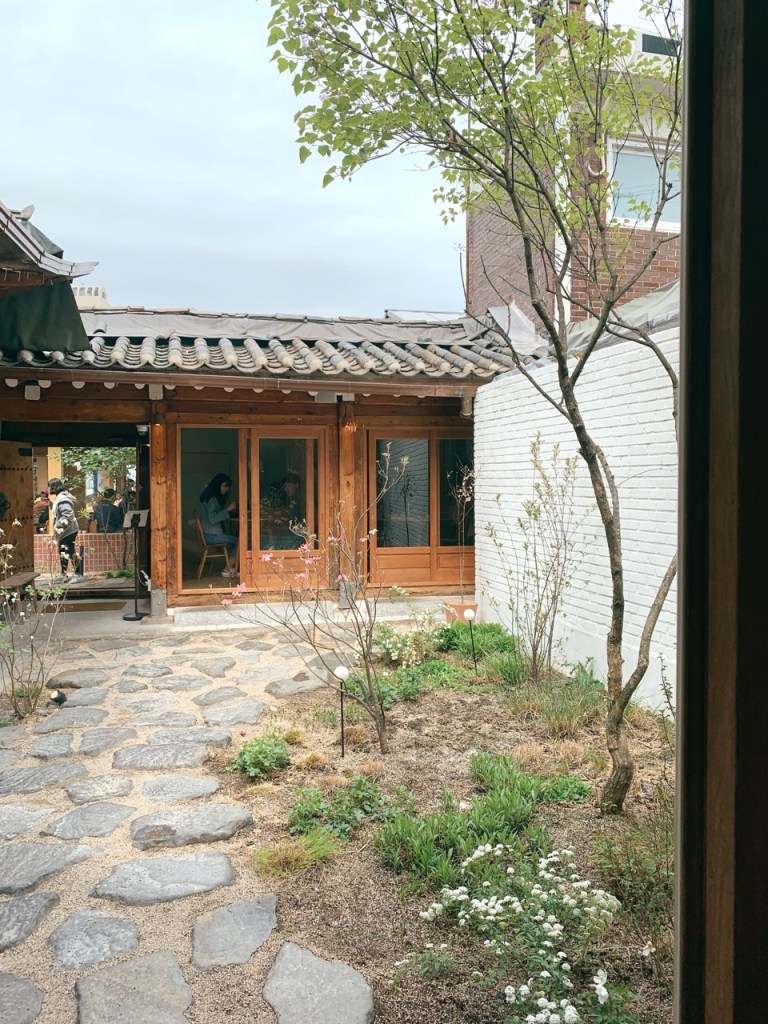 The serene small garden in the middle of the Hanok building.