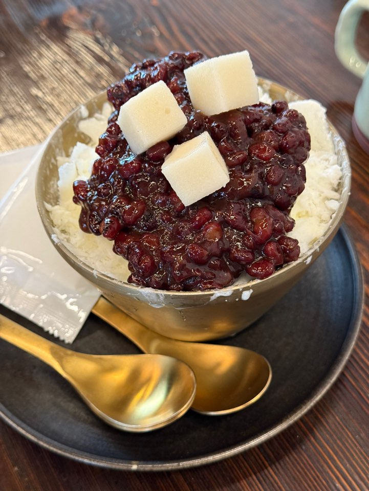 A refreshing bowl of Korean shaved ice topped with sweet red beans.