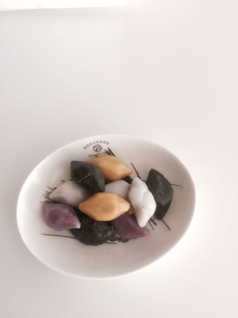 Songpyeon colored with natural ingredients like mugwort and pumpkin.