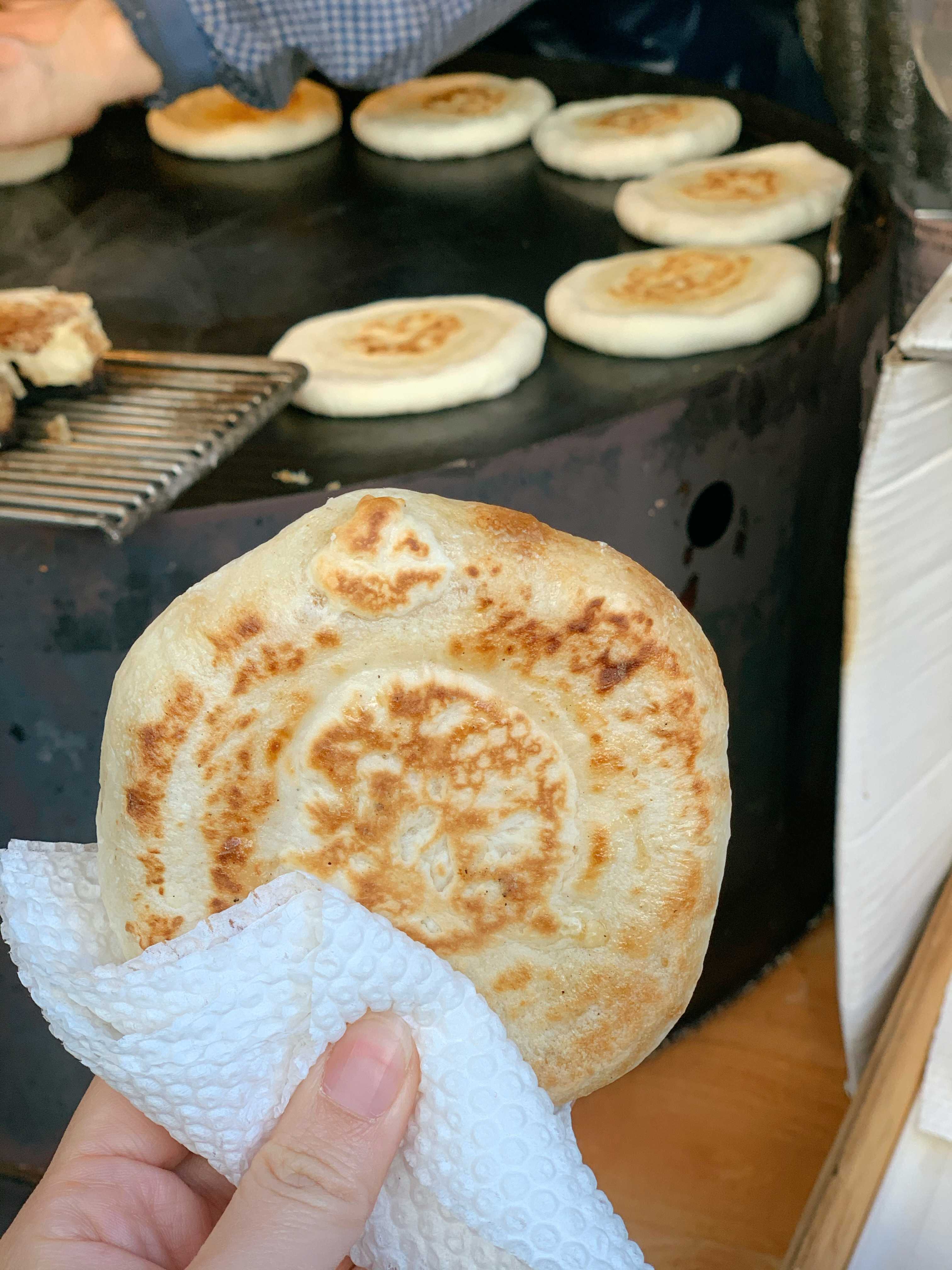 A stack of chewy, golden-brown sweet Korean pancakes (Hotteok).