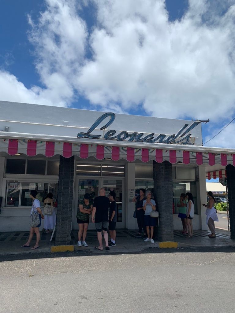 The retro neon sign and exterior of Leonard's Bakery in Honolulu.