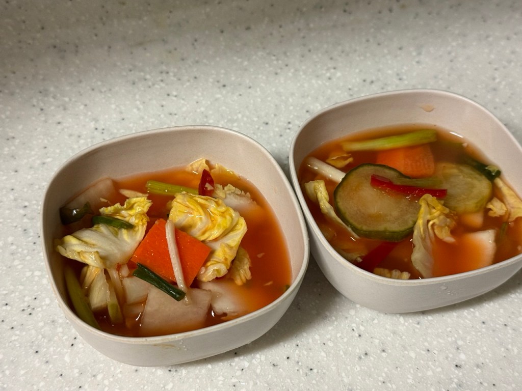 A single serving of Mul-kimchi in a small traditional Korean ceramic bowl.