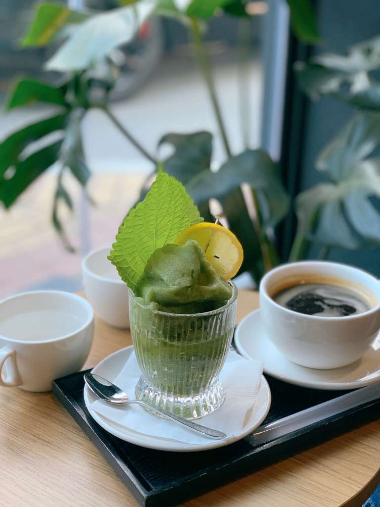 A glass of unique signature coffee or beverage served at Iridescent.