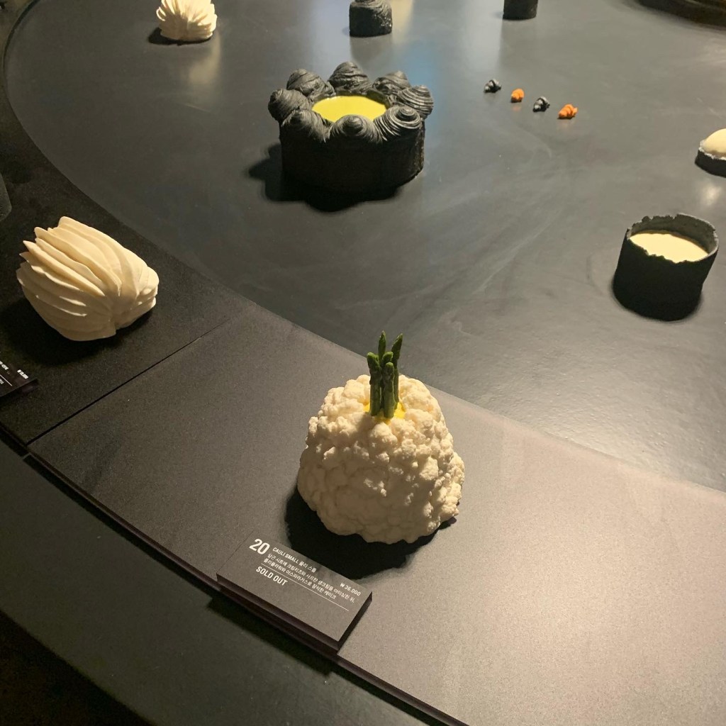 long artistic table displaying various creative desserts at Nudake.