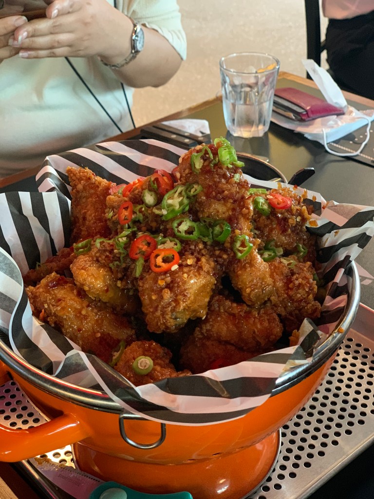 Close-up of fried chicken with a glossy and sticky sweet and spicy glaze.