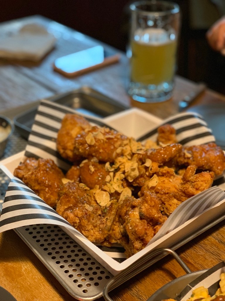 A representative shot of Korean fried chicken coated in various flavorful sauces.