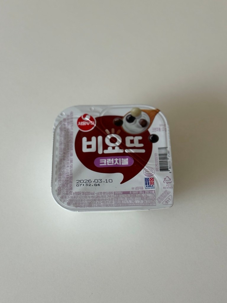 A fresh Viyott yogurt cup with separate sections for yogurt and toppings.