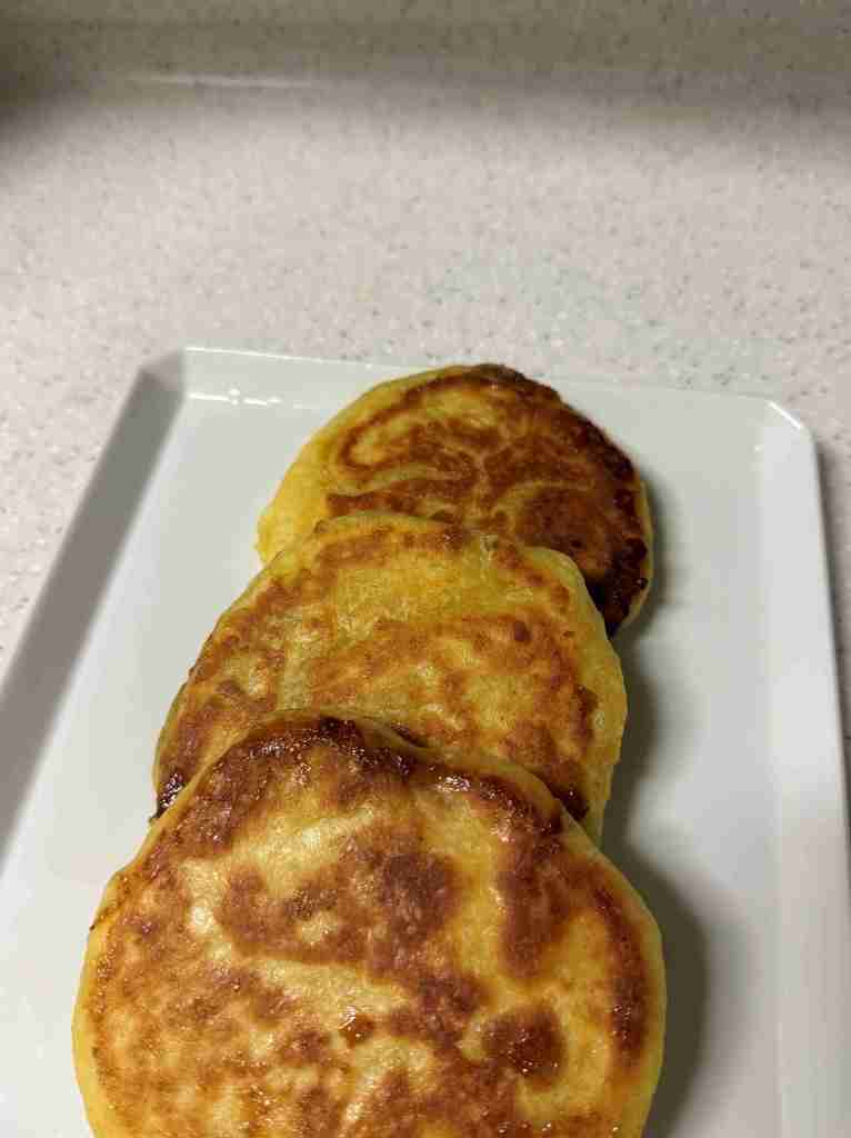 A plate of golden-brown homemade Hotteok served warm at home.
