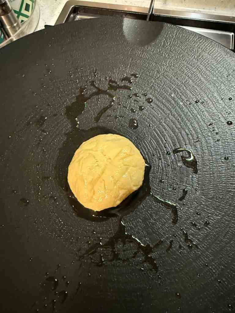 Frying the homemade Hotteok in a generous amount of oil until crispy.