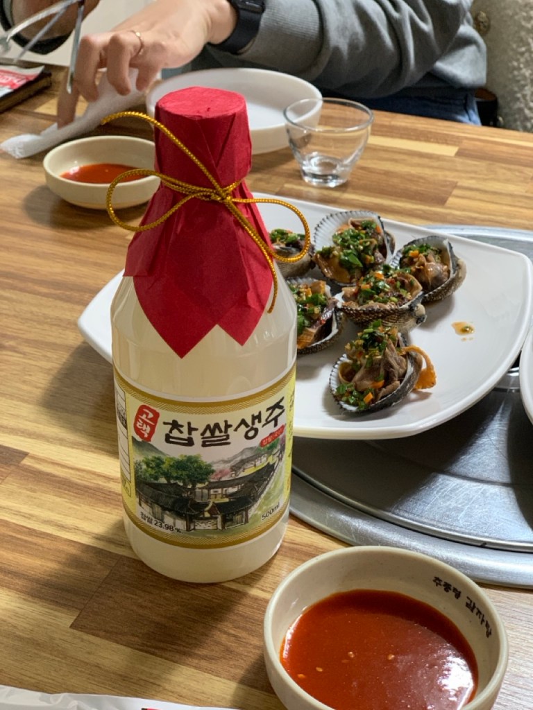 Samhap platter served with traditional Korean drinks in a cozy atmosphere.