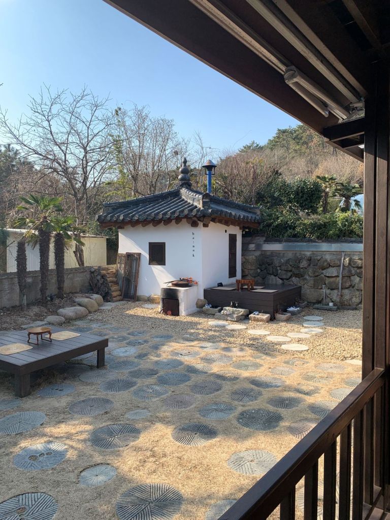 The stunning exterior of the traditional Korean hanok building with a tiled roof