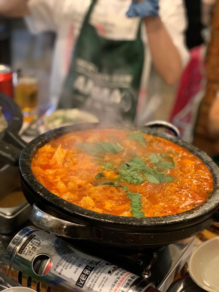 A bubbling pot of spicy beef intestine hot pot (Gopchang-jeongol) with glass noodles.
