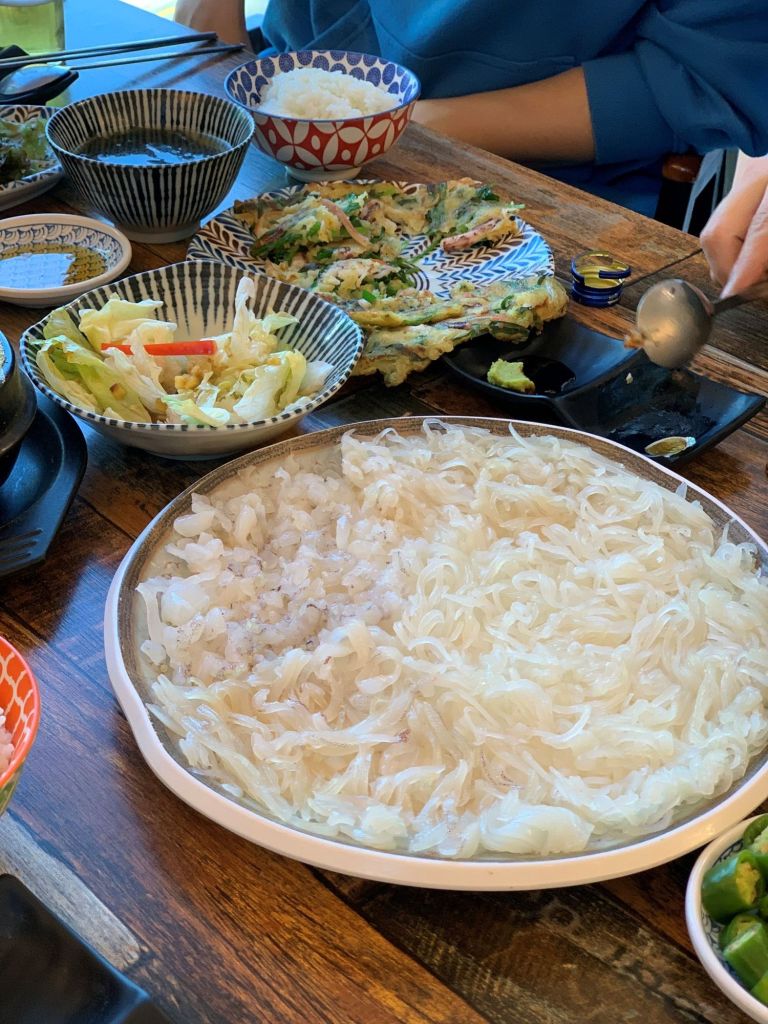 Close-up of the translucent and finely shredded squid, showcasing its freshness.