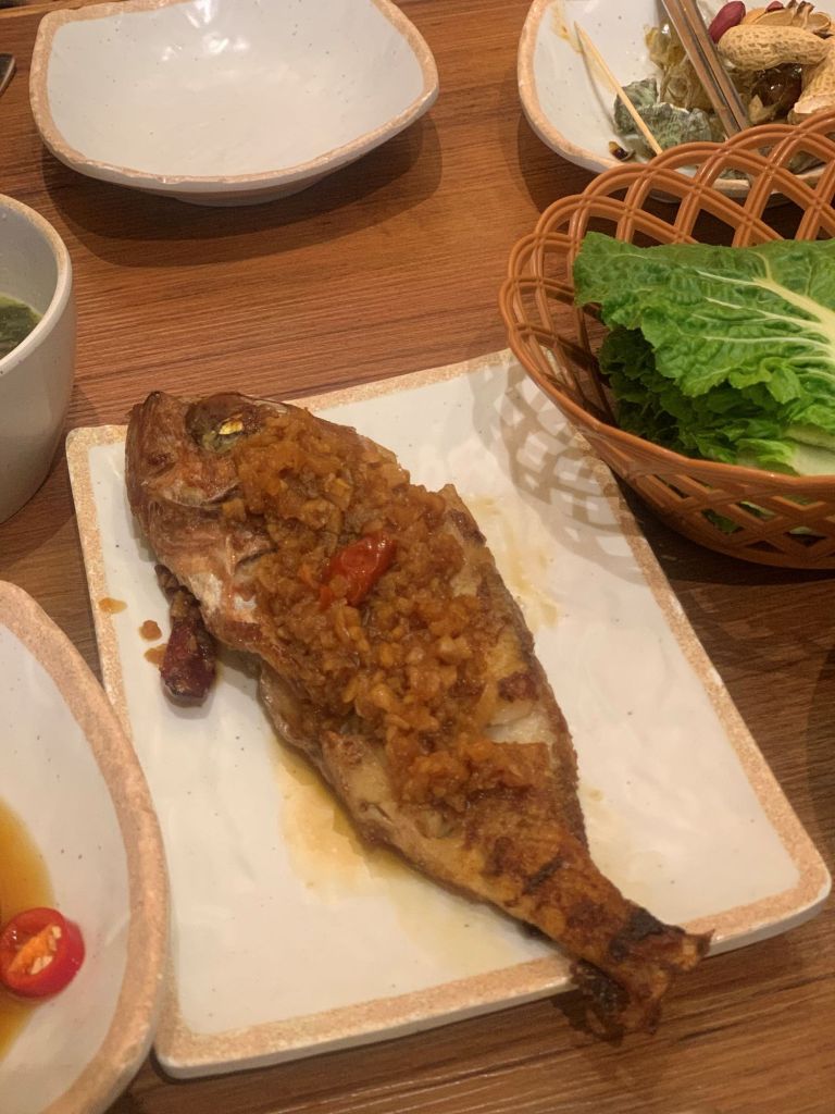 Golden-brown grilled rockfish, a delicious side dish that comes with the meal.