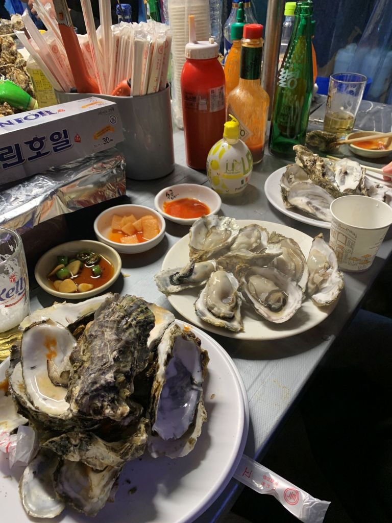 Close-up of a fresh, plump oyster meat showing its creamy and milky quality.