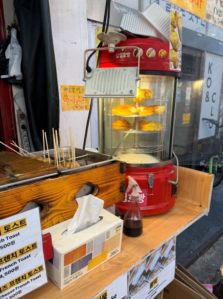 Steaming hot, fluffy bread with a whole egg inside, a classic Seoul street snack.