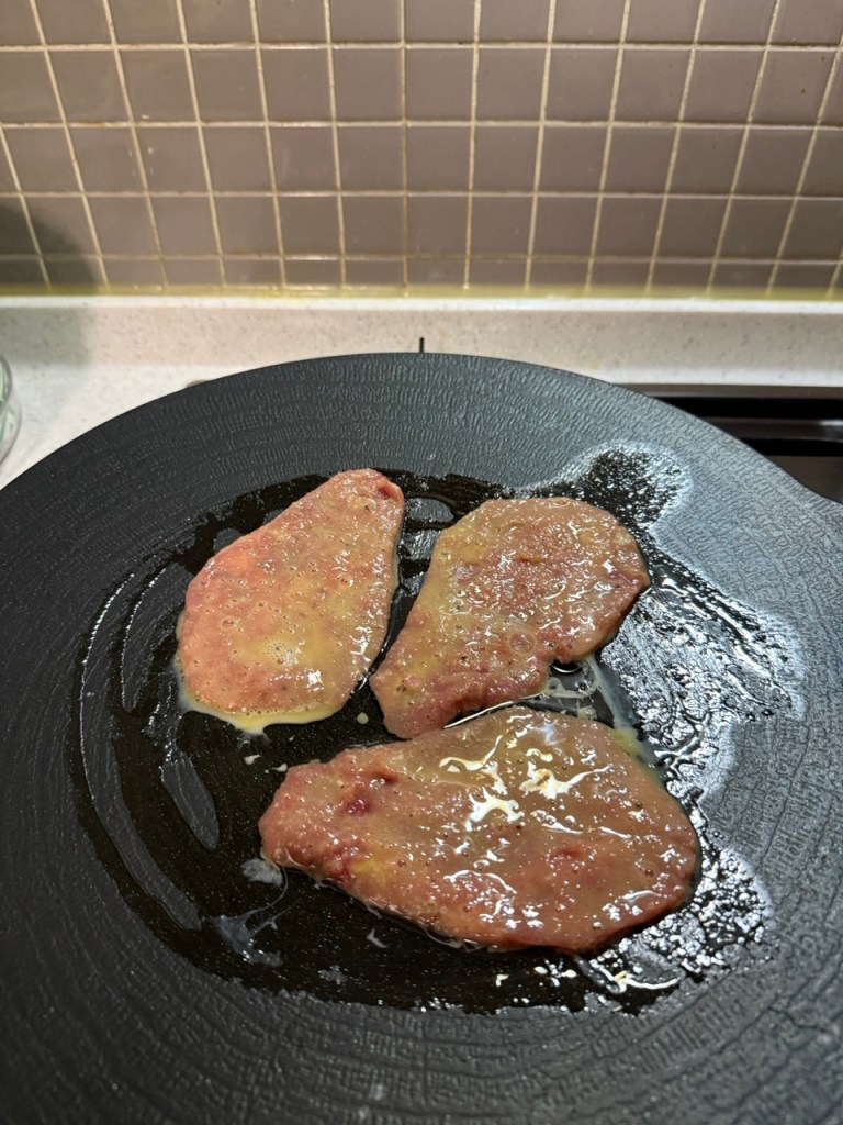 Frying the beef pancakes on a pan until they are perfectly golden.