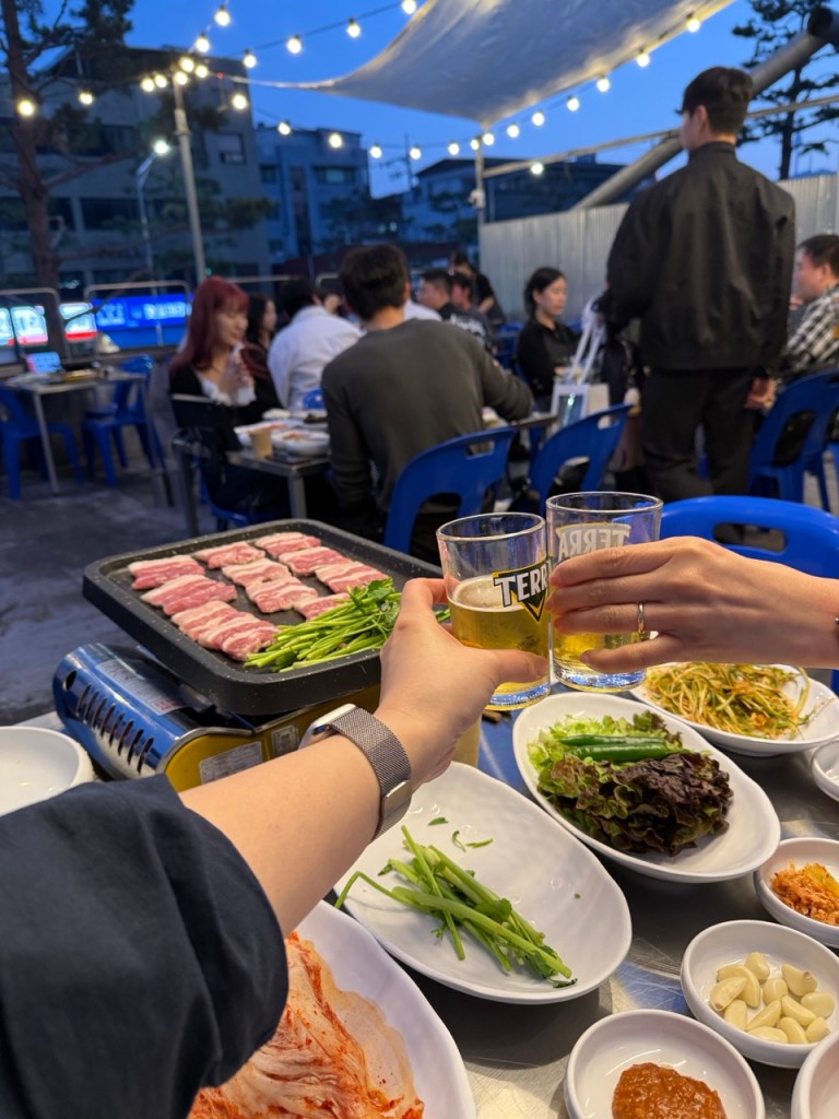 Cold beer and soju bottles on a table, the perfect drinks for outdoor BBQ.