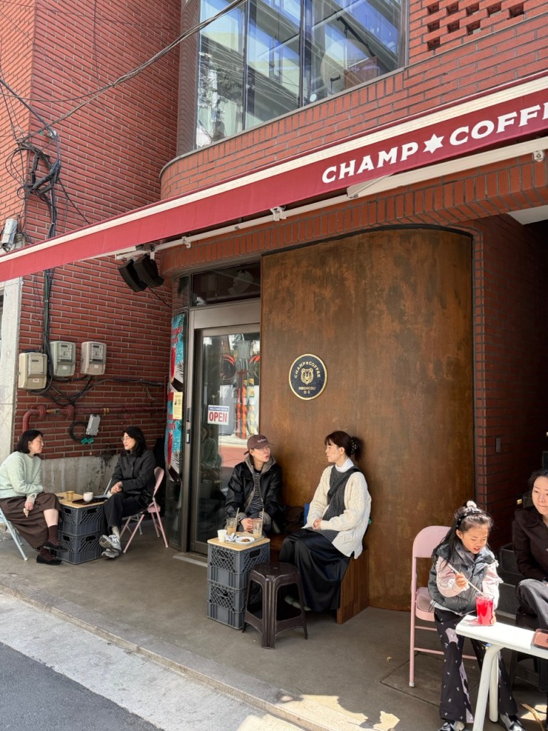 Enjoying a cold brew or latte on the trendy outdoor bench in front of the shop.
