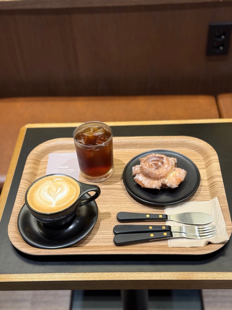 Aesthetic presentation of a classic donut on a simple, elegant plate.