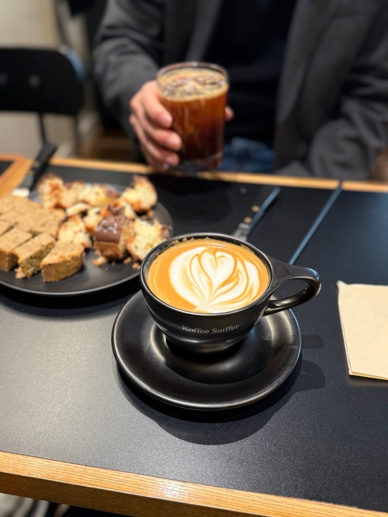 A creamy and rich signature custard latte, beautifully served in a classic glass.