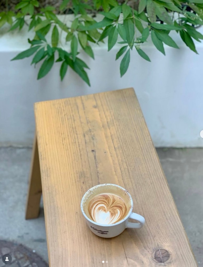 Minimalist black outdoor seating area for enjoying coffee in the fresh air.