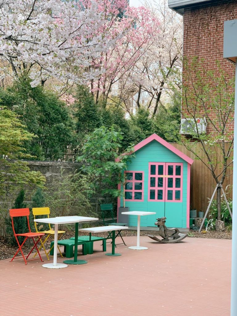 A beautiful view of cherry blossoms blooming along the red brick buildings in Seongsu-dong.