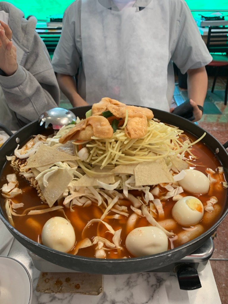 Generous portions of ramyeon and chewy jjolmyeon noodles soaking up the sauce.