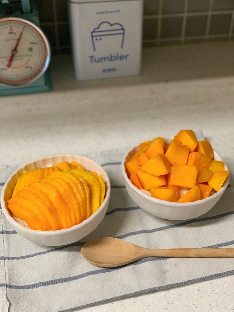 Premium shaved ice loaded with fresh, ripe mango slices and syrup.