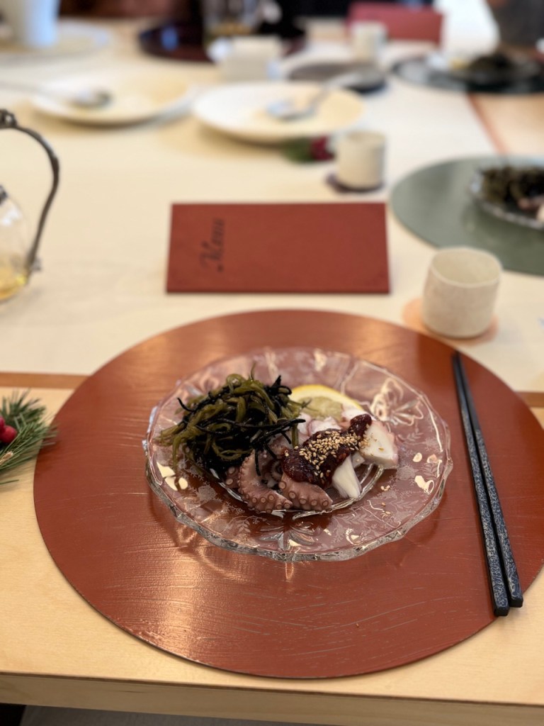 A high-end gourmet Korean meat dish served with artisan local herbs, showcasing masterful culinary execution.