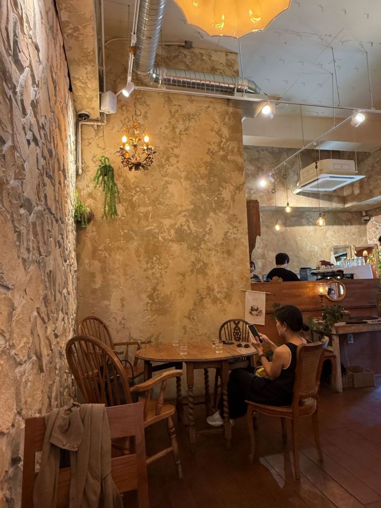 The sophisticated and moody dark-toned wooden furniture and interior design creating a relaxing ambiance at OATT.