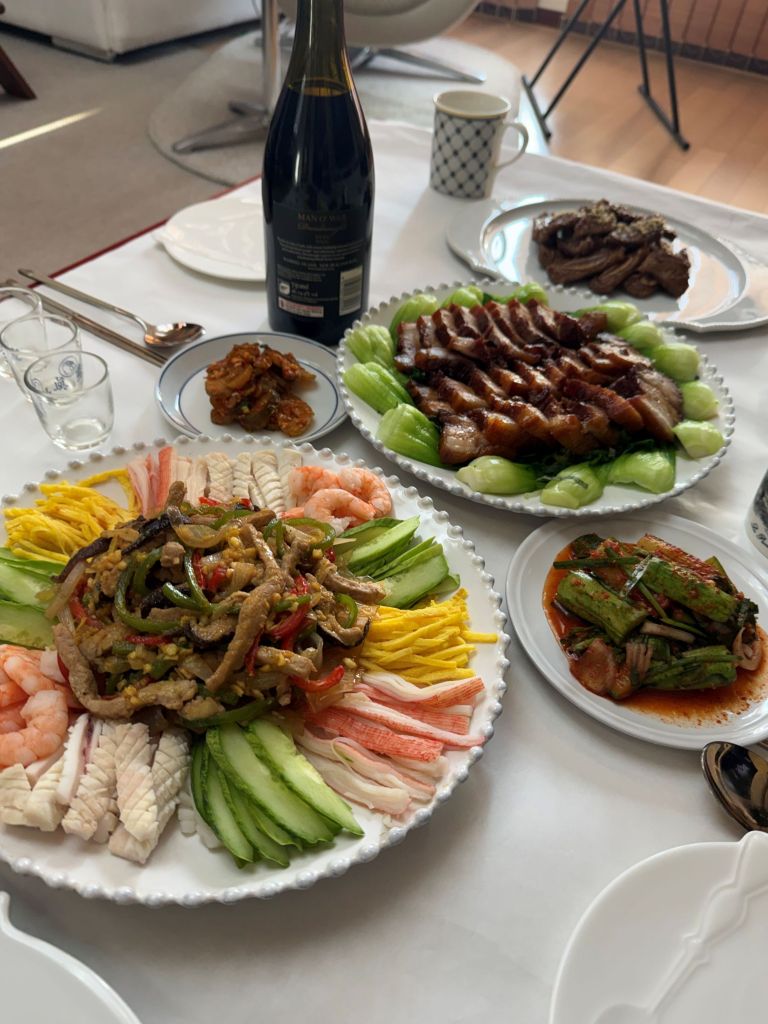 A vibrant and colorful platter of Yangjangpi, featuring assorted seafood and vegetables with mustard sauce for a festive mood.
