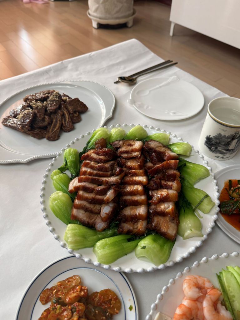 Tender and succulent homemade Dongpo pork (braised pork belly) served as a centerpiece for a celebratory family dinner.