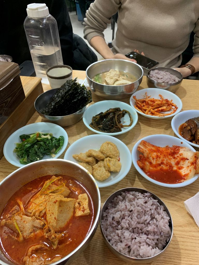 Authentic Seoul local dining experience featuring a traditional Korean home-style meal with various side dishes.