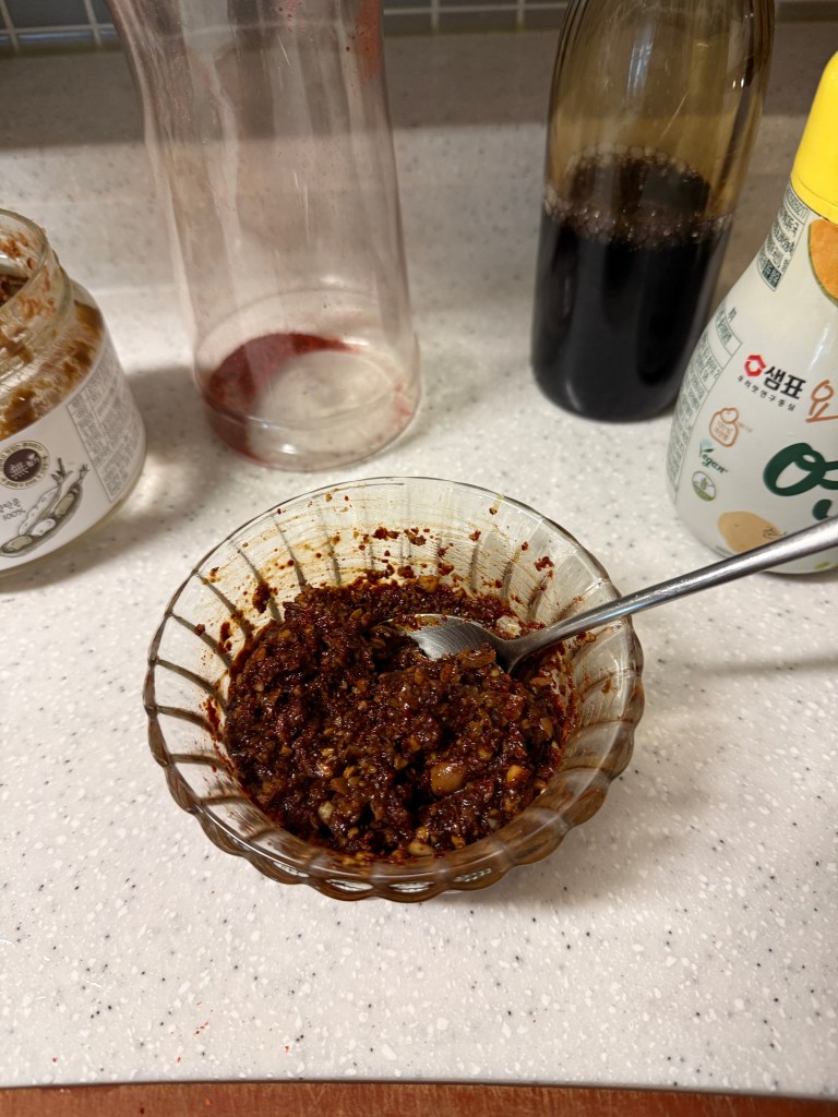 A rich and spicy Korean seasoning paste made with soybean paste, gochugaru, and minced garlic.
