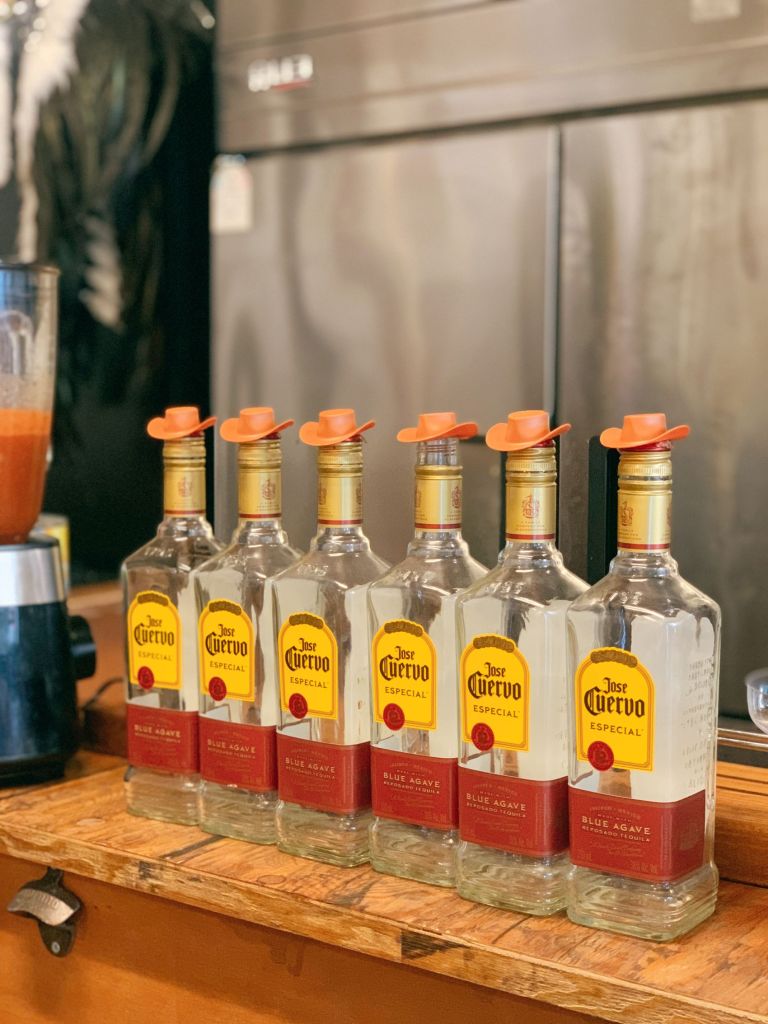 A wide selection of Mexican tequila and agave spirits displayed at the stylish bar of Raise Your Finger.