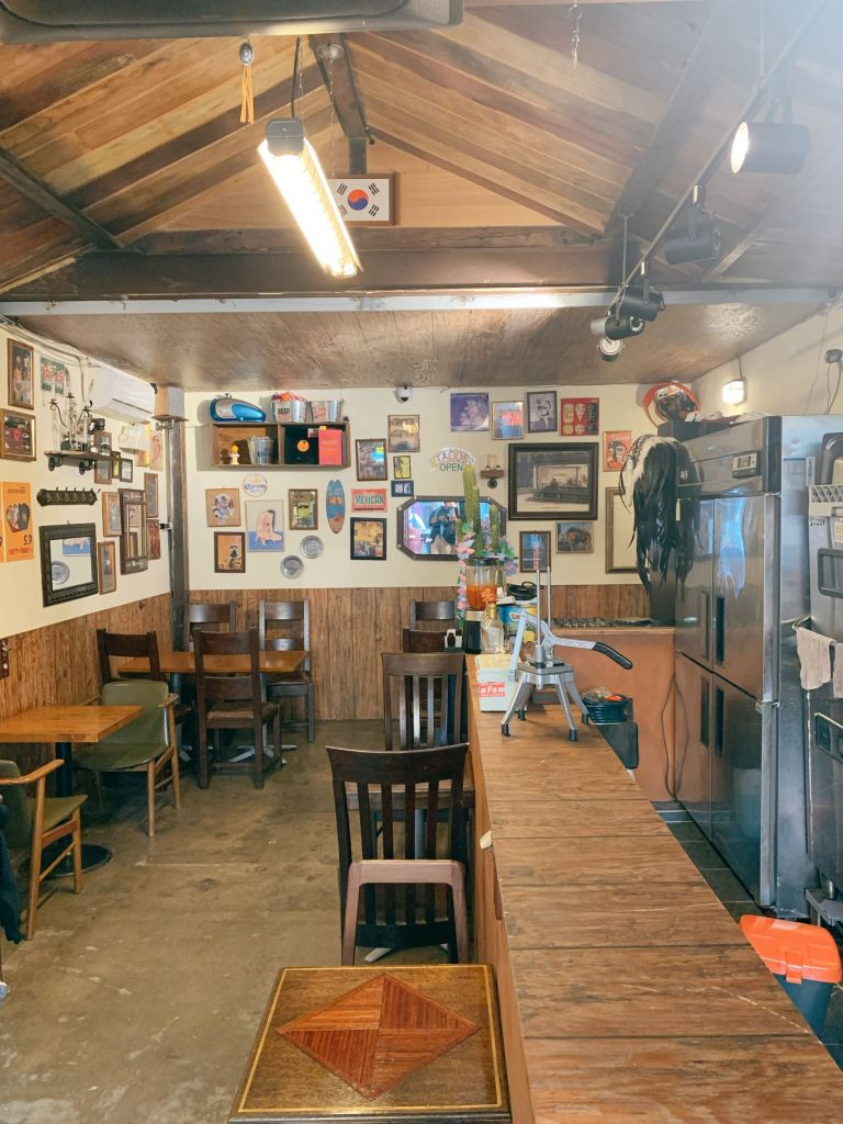 The vibrant and trendy interior of Raise Your Finger taco pub, showcasing its unique Mullae Art Village atmosphere.