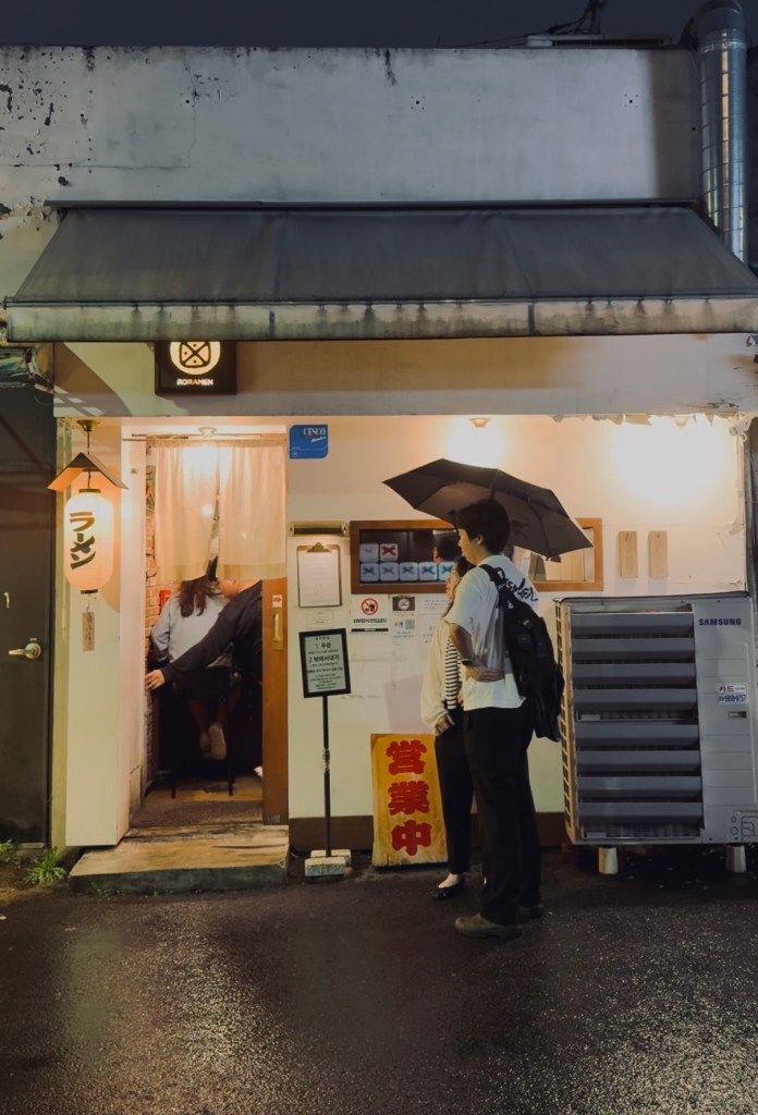 The minimalist wooden entrance of Rorammen, a popular Japanese ramen restaurant in Mullae-dong, Seoul.