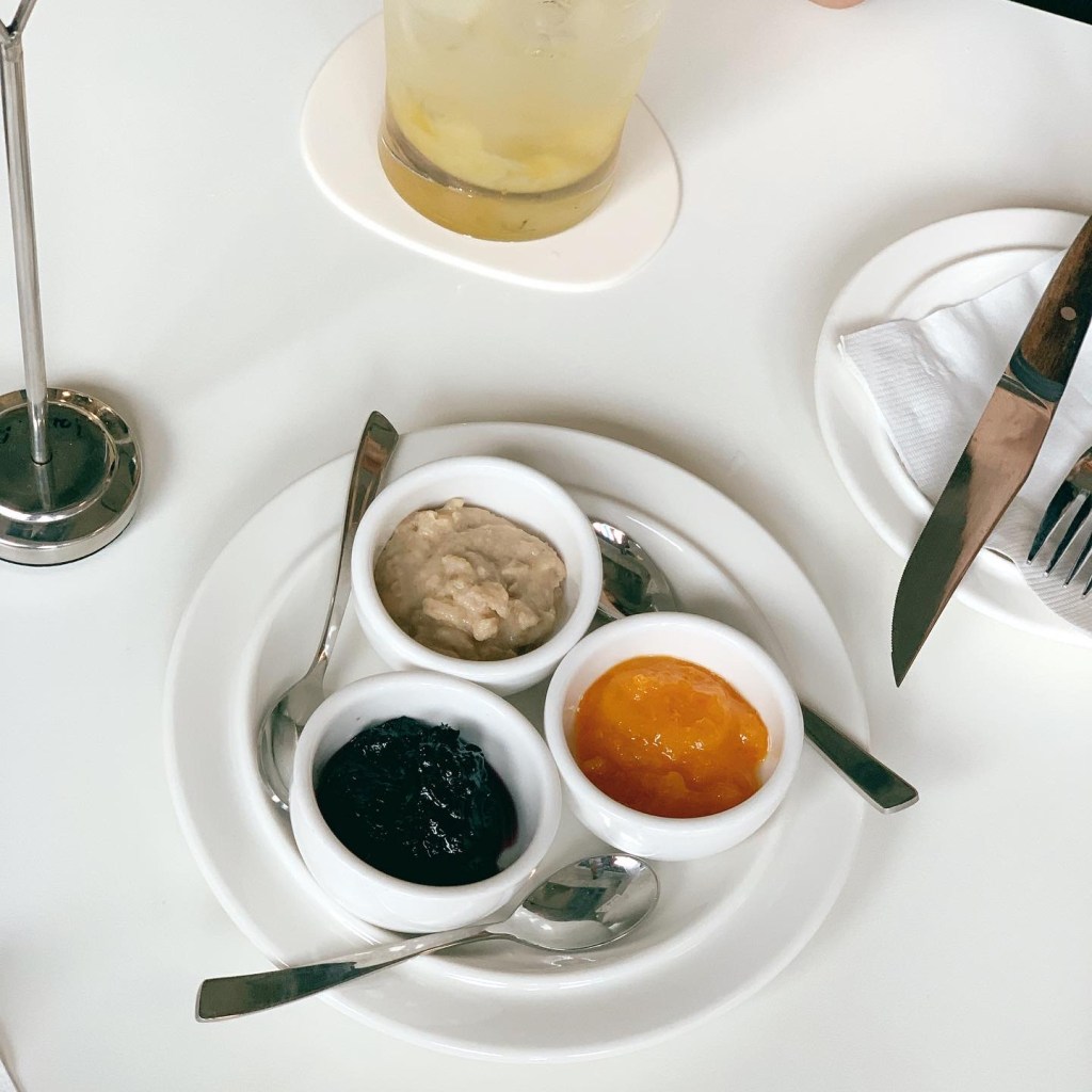 An artistically arranged platter featuring Secondé Live's colorful signature sweet and savory artisanal fruit jams and cream spreads.